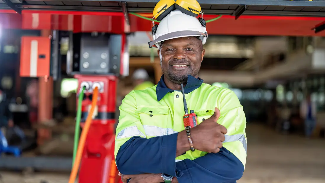 An engineer in high-visibility gear and a hard hat on site